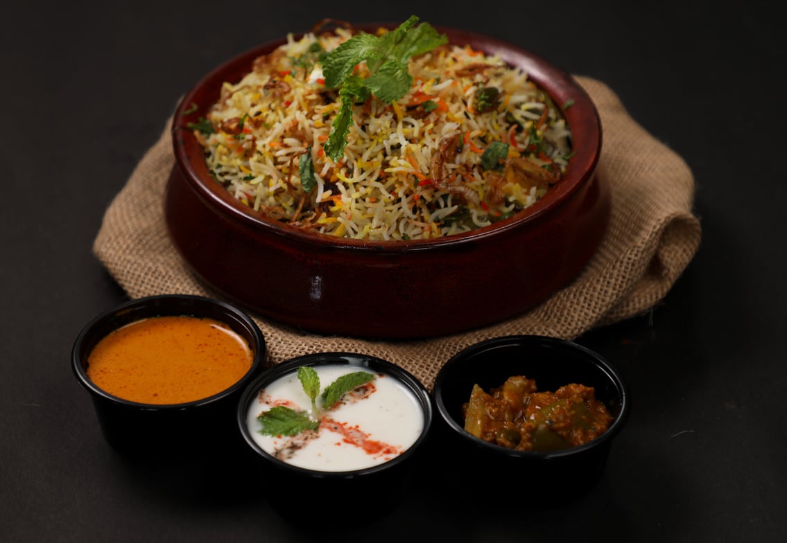 Biryani with salan , raita and pickle